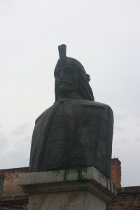 A bust of Vlad the Impaler, the model more or less for Bram Stoker's Dracula is on a pedestal outside the remains of his 15th century residence.